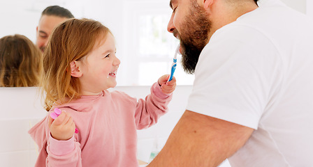 Image showing Happy family, dental and brushing teeth with girl and father in bathroom for hygiene, learning and grooming. Love, teeth and oral care by parent with daughter play, laugh and cleaning in their home