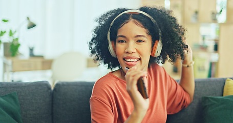 Image showing Black woman, dancing and headphones on sofa, being content and singing words in living room. Young girl, headset and digital device for contemporary dancer, moving with rhythm and relax on break.
