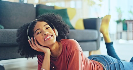 Image showing Music, laptop and relax girl on floor carpet streaming radio rap, disco or rock song while singing trendy audio. Headphones, energy or student black woman listening to wellness sound and typing on pc