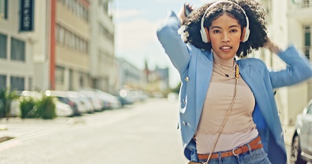 Image showing Music, street and black woman dance with energy, wellness and freedom while streaming rap, hip hop or radio sound. Headphones, crazy fun and retro dancer listening to audio song while dancing in city