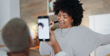 Image showing Music, dance and singing with a phone in the hand of a woman for recording, fun or being playful. Joke, dancing and happy with an attractive young female enjoying free time and playing in a home