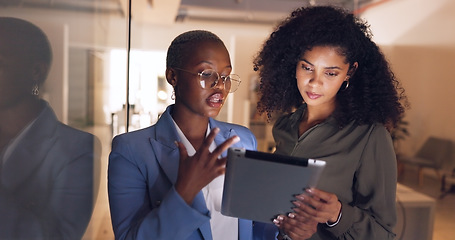 Image showing Black women, business and tablet in discussion or meeting for corporate strategy, planning or collaboration at office. African woman executive talking to employee on touchscreen technology at work