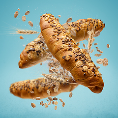 Image showing Freshly baked rolls fly in the air.