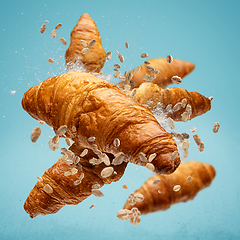 Image showing Freshly baked croissant flying in air