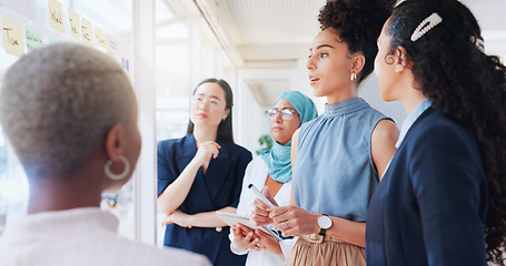 Image showing Sticky note, planning and business women in meeting sit down in office. Teamwork, collaboration and group of people sitting after brainstorming sales, advertising or marketing strategy on glass wall.