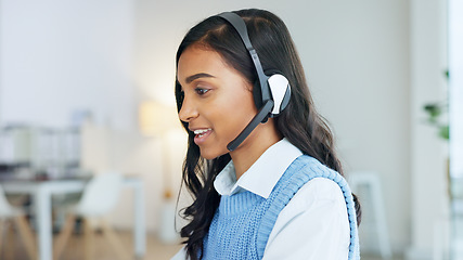 Image showing Friendly call center agent using a headset while consulting for customer service and sales support. Confident and happy young business woman smiling while operating a helpdesk and talking to clients