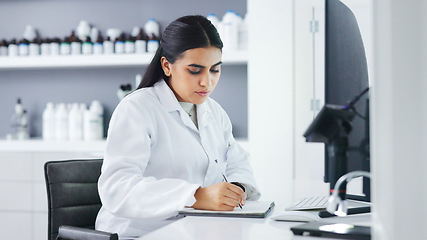 Image showing Young scientist using a computer and microscope in a lab. Female pathologist analyzing medical samples while doing experiments to develop a cure. Microbiologist conducting forensic research