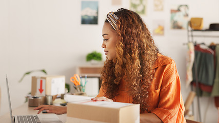 Image showing Clipboard, laptop and black woman writing in clothing store working on sales or delivery. Fashion, manager and worker in South Africa in small business, fashion shop and planning schedule on computer