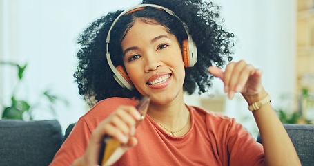 Image showing Black woman, dancing and headphones on sofa, being content and singing words in living room. Young girl, headset and digital device for contemporary dancer, moving with rhythm and relax on break.