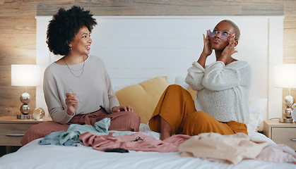 Image showing Fashion, bedroom and friends choosing clothing for girls night out. Happy, smile and black woman on bed with friend sharing clothes. Women help with outfit choice for interview, social event or date.