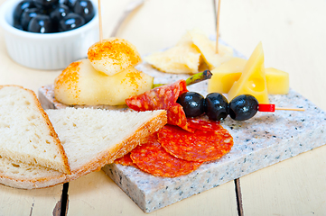 Image showing mix cold cut on a stone with fresh pears