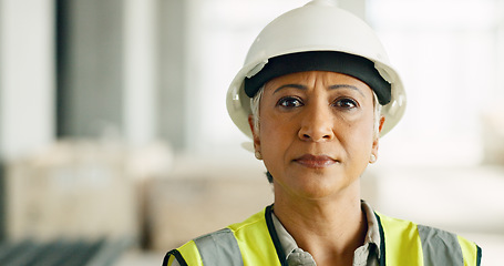 Image showing Woman, serious face and construction worker, engineer at work site and business, building trade industry portrait. Mature person, safety helmet and professional, engineering and construction job.