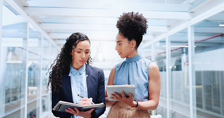 Image showing Mentor, discussion and business women walking in office workplace. Leadership, coaching and group of people or employees in hallway talking, planning or brainstorming project with tablet and books.