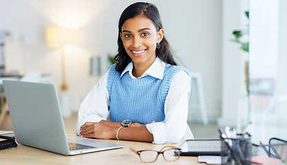 Image showing Portrait of a young entrepreneur networking with clients online using her laptop. One happy female corporate intern browsing the internet and typing and sending emails for her manager