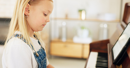 Image showing Development, young girl and piano for learning, practice and keys for instrument being focus, concentrate and educate. Music, tablet and child education for playing, lesson and training art at home.