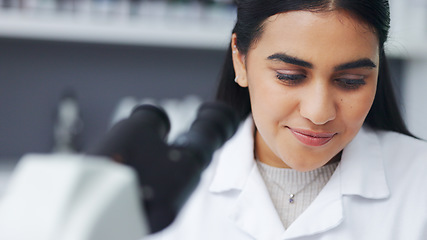 Image showing Young scientist using a digital tablet and microscope in a lab. Female pathologist analyzing medical samples while doing experiments to develop a cure. Microbiologist conducting forensic research