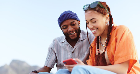 Image showing Couple, diversity love and phone in nature, outdoors or outside on holiday, vacation or trip. Happy, smile and man, woman and 5g mobile app, social media or web surfing online on tech while talking.