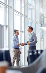 Image showing Business people, handshake or greeting in hotel lobby, modern office or airport lounge in CRM meeting. Smile, happy or mature workers shaking hands in partnership deal, collaboration or b2b agreement