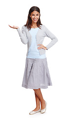 Image showing Fashion, portrait and woman with product mockup in a studio for placement, marketing or advertising. Happy, smile and female model weighing mock up space with her hand isolated by a white background.