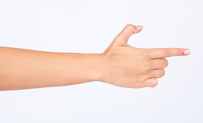 Image showing Hand, finger and pointing with a woman in studio isolated on a white background making a gun gesture. Social media, icon and emoji with a female on blank space to choose a decision or point right