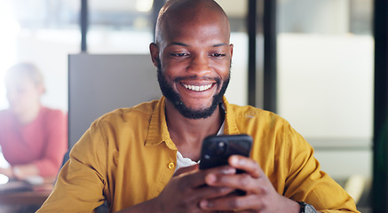 Image showing Black man, phone and office chat while online for communication, social media or reading email, news or content creator post. Smile on face of employee at desk for project research on website