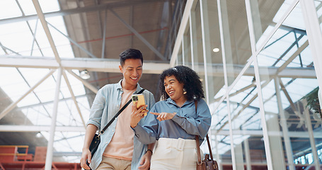 Image showing Phone, black woman and man walking in a office building talking, reading or sharing online social media news. Social networking, mobile app or employees in communication or speaking of internet