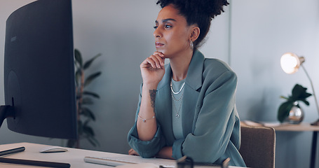 Image showing Computer, thinking and black woman typing in office writing email at night. Working late, planning and female worker with solution working on sales, advertising or marketing ideas, report or proposal