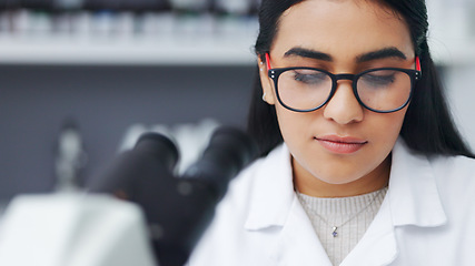 Image showing Closeup of a young female scientist using a microscope analysing medical test results or samples in a research lab. Young woman doing forensic science and experiment to develop or discover a cure