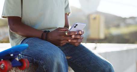 Image showing Skater hands, phone or networking on social media app, internet search or digital iot. Zoom black man with 5g communication technology planning schedule, writing email or contact us page on website