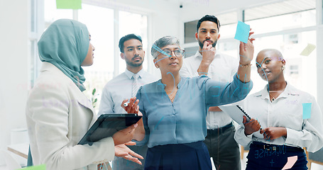 Image showing Leadership, writing or business people with sticky notes for planning marketing SEO calendar, vision or mission. Teamwork, diversity or business woman in meeting for data analysis or strategy review