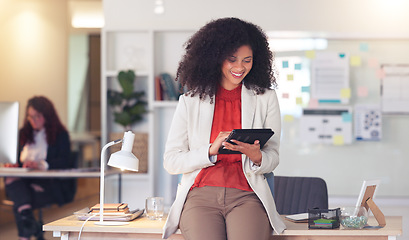 Image showing Confident entrepreneur and cheerful HR manager feeling ambitious and motivated for success while planning project ideas online. Happy business woman browsing on a digital tablet in a modern office.