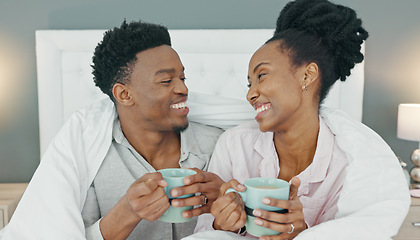 Image showing Happy, couple and coffee in bed of black people relax and calm with happiness in a house bedroom. Smile, love and calm home experience of a man and woman together with a blanket drinking tea