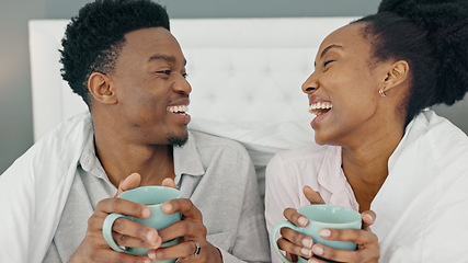 Image showing Coffee, smile and a couple drinking in bed together on a lazy day at home. Love, a winter warm up and a hot beverage on a cold morning, black woman and happy man with duvet and a fresh cup in bedroom