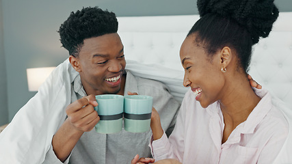 Image showing Smile, love and happy black couple drink a cup of coffee on a bed in the morning at home. People in loving, smiling in the bedroom with a warm beverage. Romantic young man and woman bonding in house