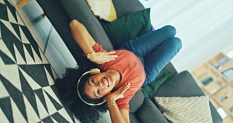 Image showing Headphones, listening and dance of black woman on a sofa excited for subscription service, technology and home connection. Happy, relax and girl portrait dancing on couch while listening to music app