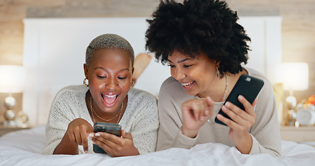 Image showing Friends, phone and girls night in bedroom on social media. Happy, smile and black woman on bed with friend watching funny video. Women at sleep over, reading and exited for online dating app message.