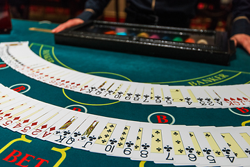 Image showing Professional croupier during cards