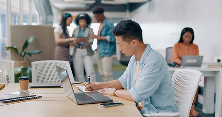 Image showing Writing, research and laptop with businessman in office with notebook for thinking, idea or planning. Marketing, administration and strategy with asian employee in startup for review, blog or website