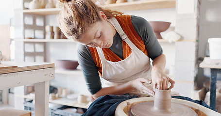 Image showing Pottery, woman creative and mold clay art piece for class, hobby or relax in workshop or studio. Creativity, girl student or female sculptor use wheel spinning, shape art or ceramic design workspace.