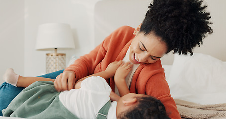 Image showing Mother, child and love in home bedroom lying in bed together for fun, tickling and laughing on happy vacation. Black woman parent playing with child for wellness, quality time and holiday memory