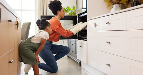 Image showing Mother, girl and baking high five in kitchen, teamwork and celebration in home. Love, support and bonding mom and girl put tray in oven, cooking or collaboration, success or working together in house