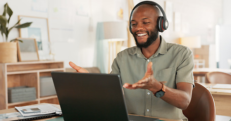 Image showing Laptop, headphones and black man on an online video call or meeting for his remote corporate job. Happy, talking and African guy on a webinar, video conference or seminar call with a computer at home