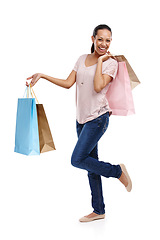 Image showing Studio, fashion and portrait of woman with shopping bags isolated on a white background. Black Friday discount, sales deals and happy female customer holding gifts after buying at mall, store or shop