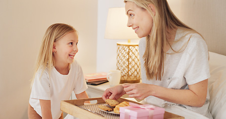 Image showing Breakfast, child and mama with a gift on mothers day in the morning to celebrate her mommy at home. Smile, Love and happy girl giving parent a present box and a croissant with cookies in a bedroom