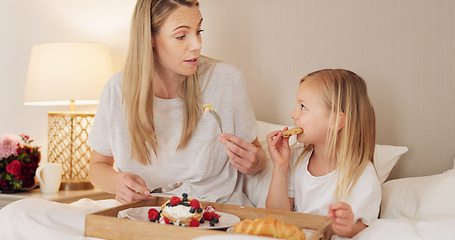 Image showing Mother, child and breakfast in the bed of their house together in the morning. Girl relax, calm and in peace while talking and eating food on mothers day with her mom in the bedroom of their home