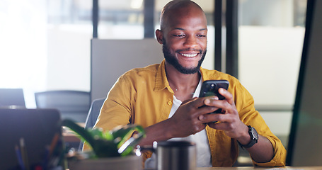 Image showing Black man, phone and office chat while online for communication, social media or reading email, news or content creator post. Smile on face of employee at desk for project research on website