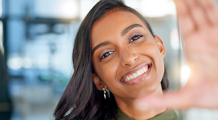 Image showing Face of a happy business woman smiling, making funny expressions and creating a frame with her hand while standing in an office at work. Portrait of a smiling, carefree and cheerful female having fun