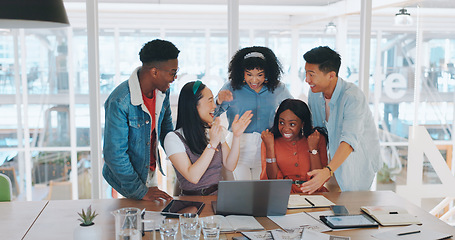 Image showing Laptop, winner and a team high five while in celebration together of a goal, target or deal in the office. Applause, diversity and success with a man and woman employee group celebrating at work