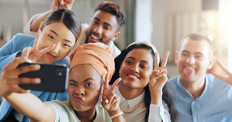 Image showing Phone selfie, peace sign and business team in startup office of creative marketing agency. Teamwork, diversity and happy men and women smile for crazy photo on smartphone in modern office.