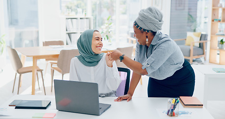 Image showing Muslim, women team and laptop with support, advice or conversation for coaching in digital marketing. Black woman, coach or mentor for islamic woman in office with fist bump, learning and celebration